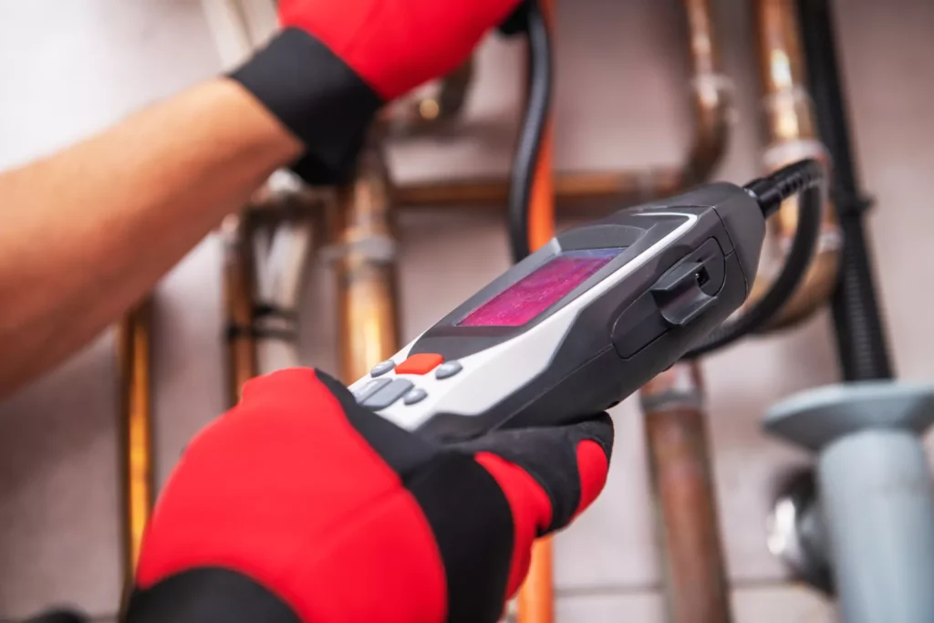Technician Uses Advanced Gas Detecting Device to Inspect Natural Gas System
