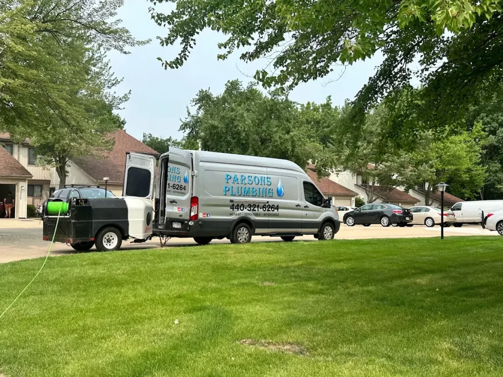 parsons plumbing van parked in a suburban street
