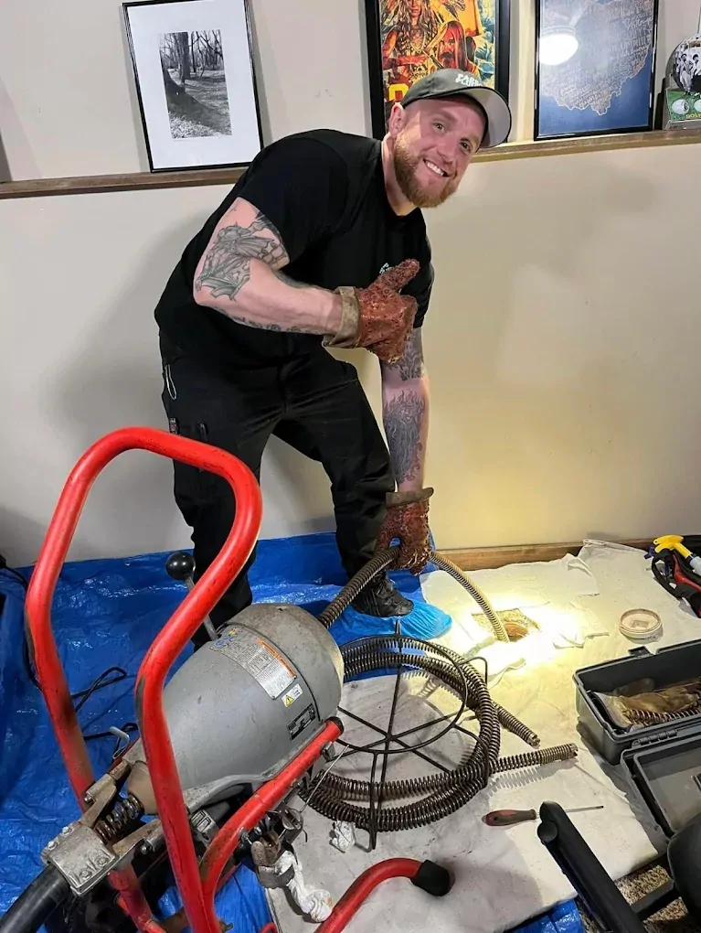 parsons worker unclogging a drain