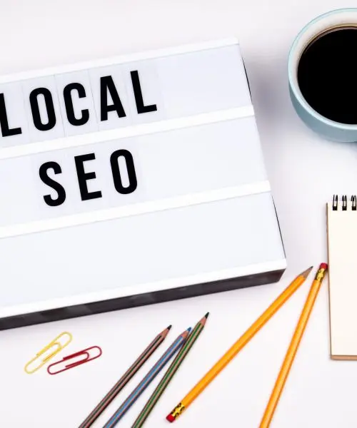 local seo text in lightbox white desk with stationery