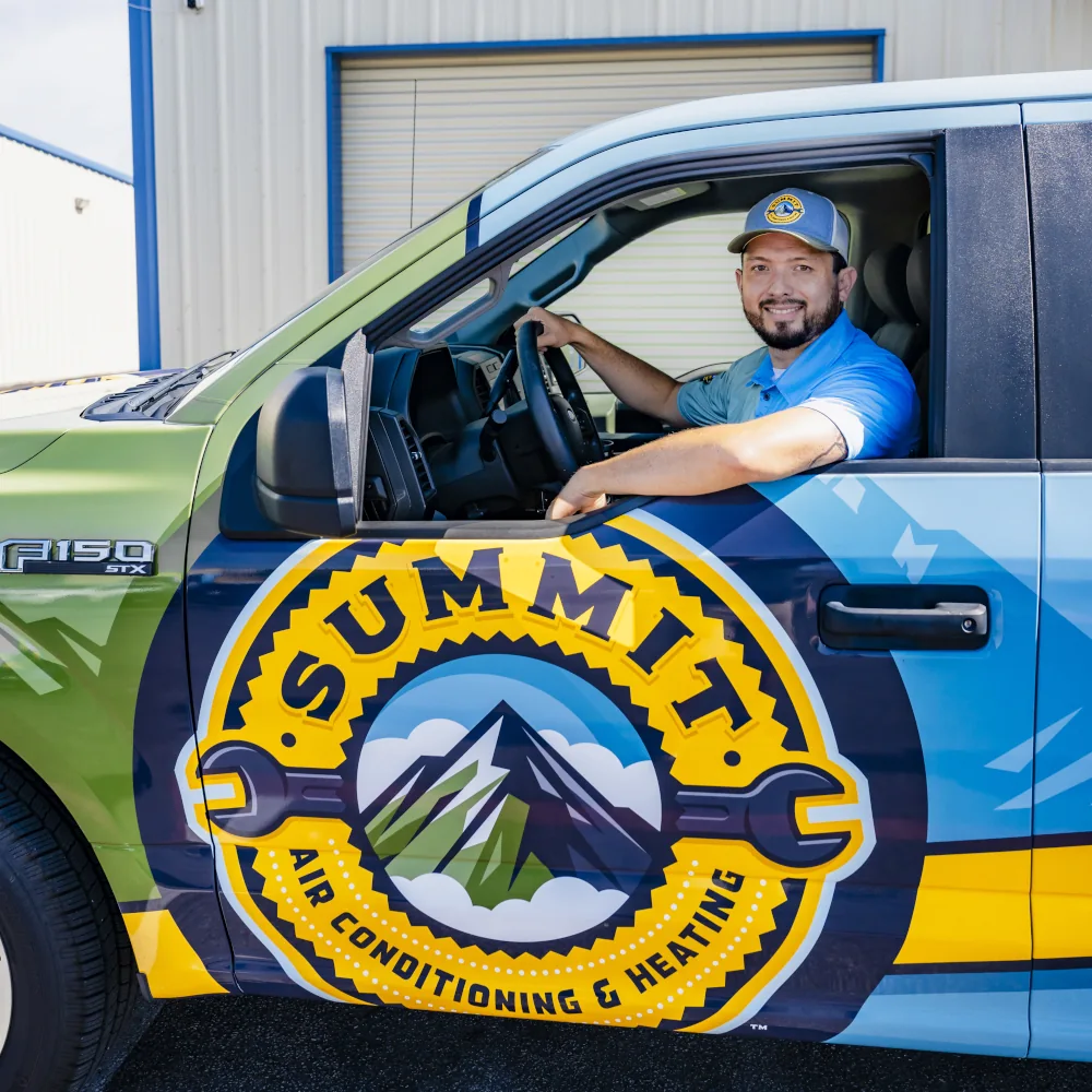 Summit AC crew member driving a company truck