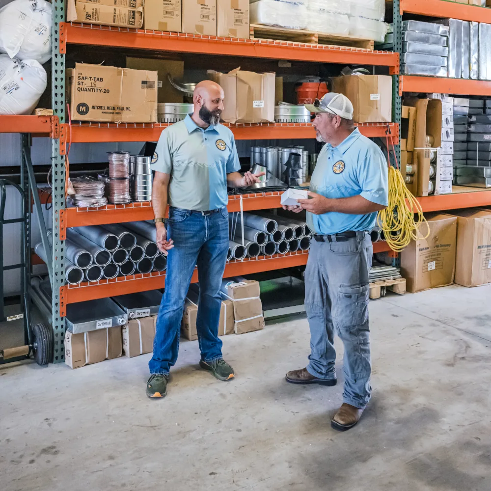 2 Summit AC crew members in a storage room