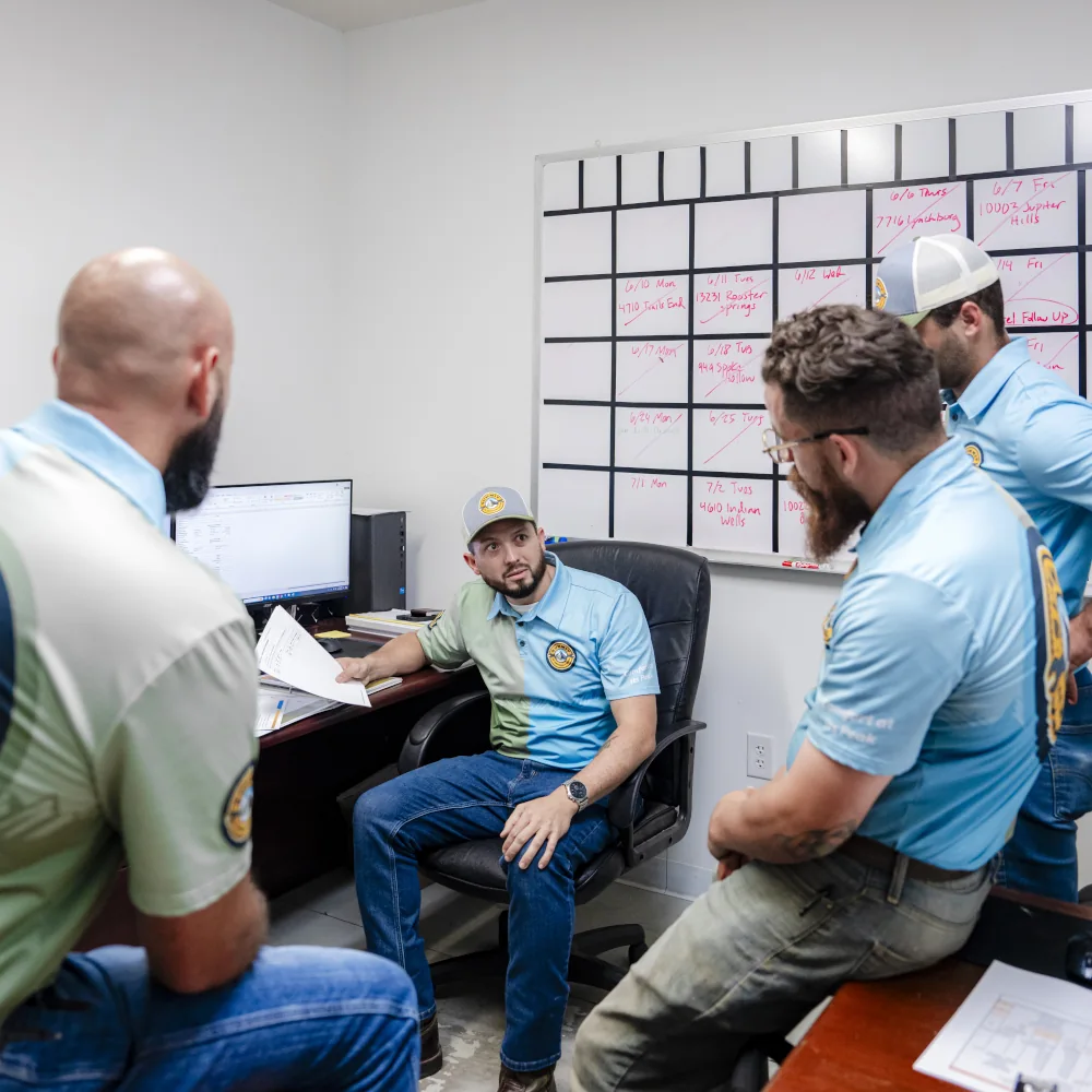 4 Summit AC crew members talking inside an office