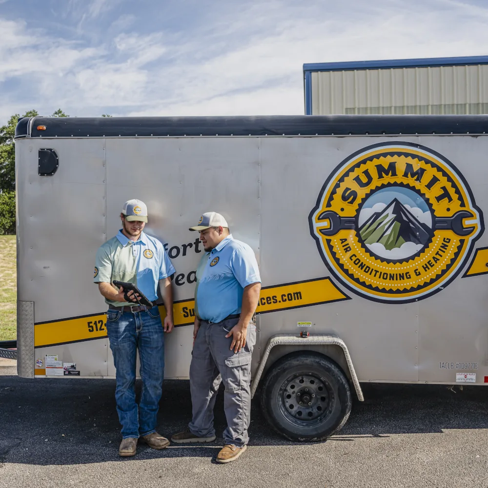 2 members of the Summit AC team and a company vehicle on the back