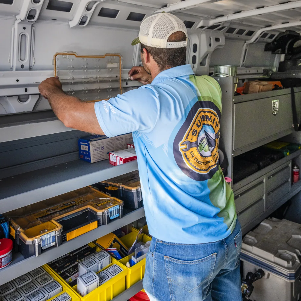 Summit AC crew member inspecting tools