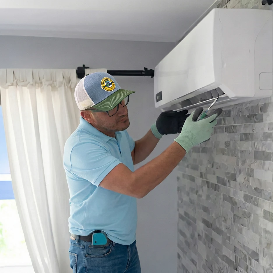 Technician inspecting a mini split unit