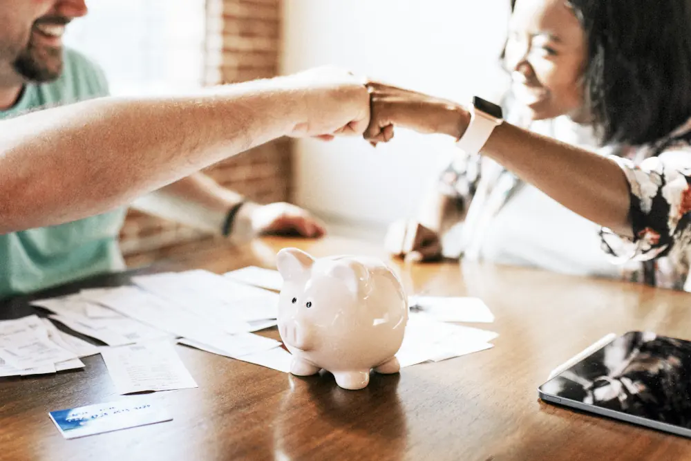 Couple doing a fist bump after doing their bills