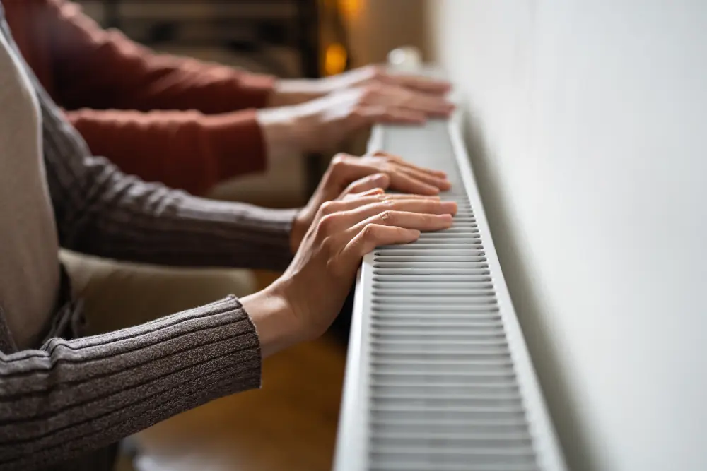 Hands close to radiator