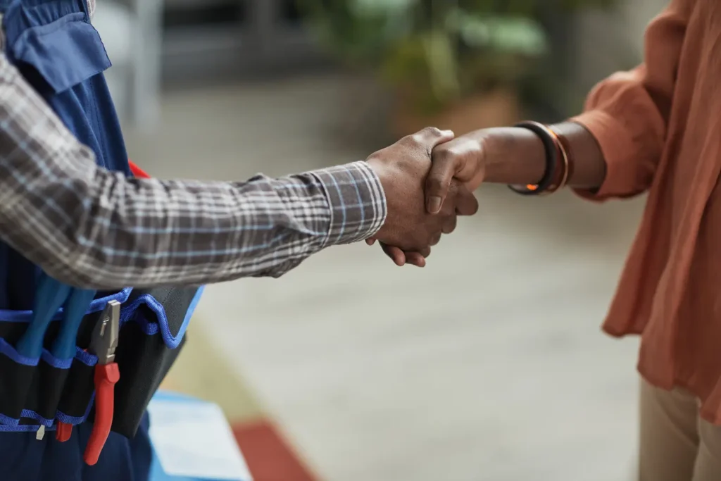 HVAC technician and client handshaking