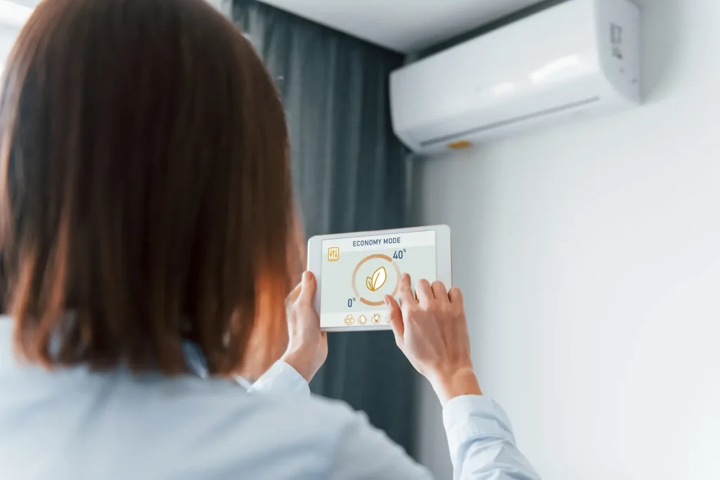 Woman controling their mini split with a smart home app