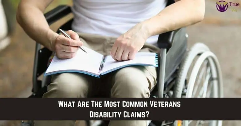 Veteran filling out VA disability form Veteran in wheelchair writing in a notebook for VA disability claims.