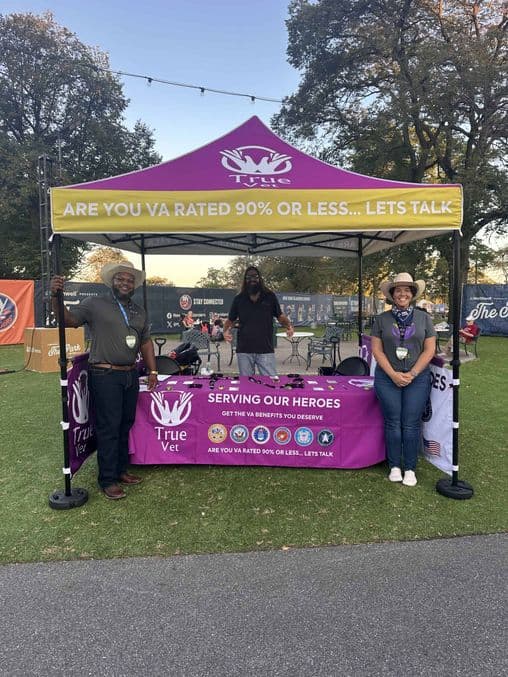 Community event booth with veterinary staff promoting pet health and services.