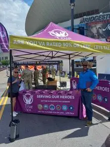 A VA benefits information booth with TrueVet Solutions at a public event.