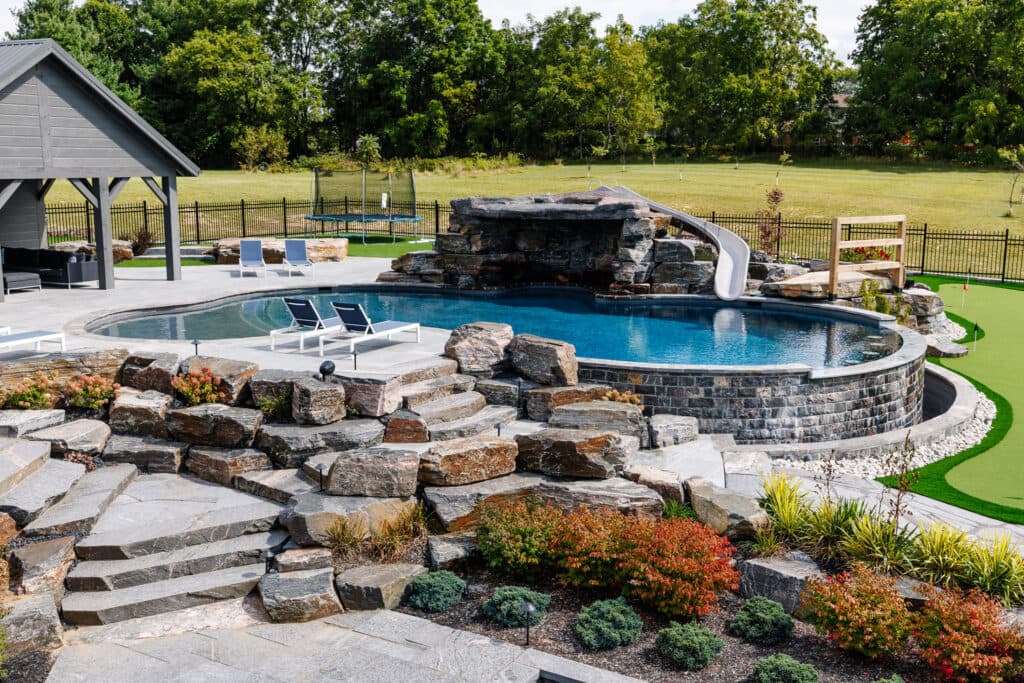 CUSTOM SWIMMING POOL WITH GROTTO & SLIDE