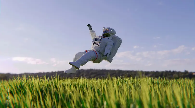 Astronaut floating on grass