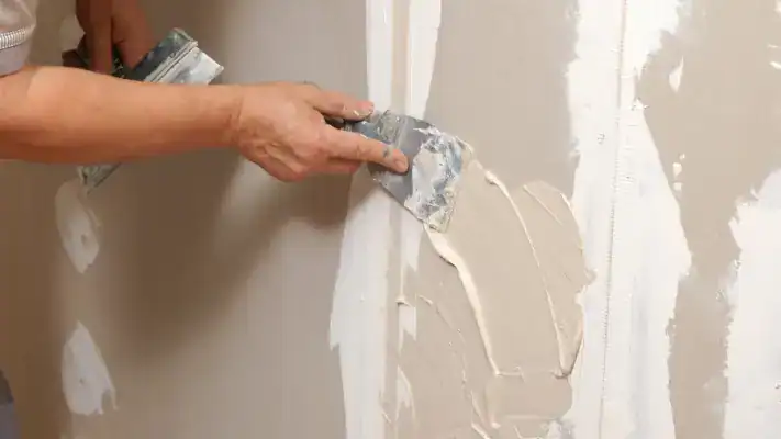 Imperfections are sanded holes filled with spackle before painting begins