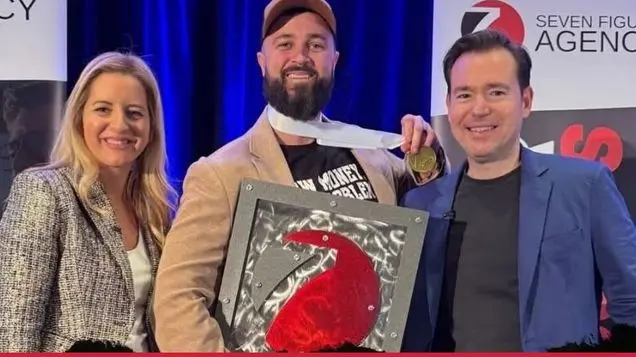 Matt Foreman receiving his Seven Figure Agency award with Josh and Yesenia Nelson