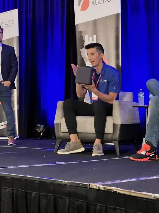 On stage at a Seven Figure Agency Intensive sharing what is working at Lift