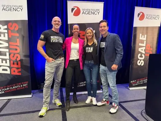 Josh Crouch on stage with Josh and Yesenia Nelson at a Seven Figure Agency event