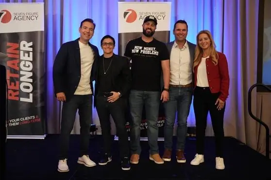 Matt Foreman on stage with the Seven Figure Agency team