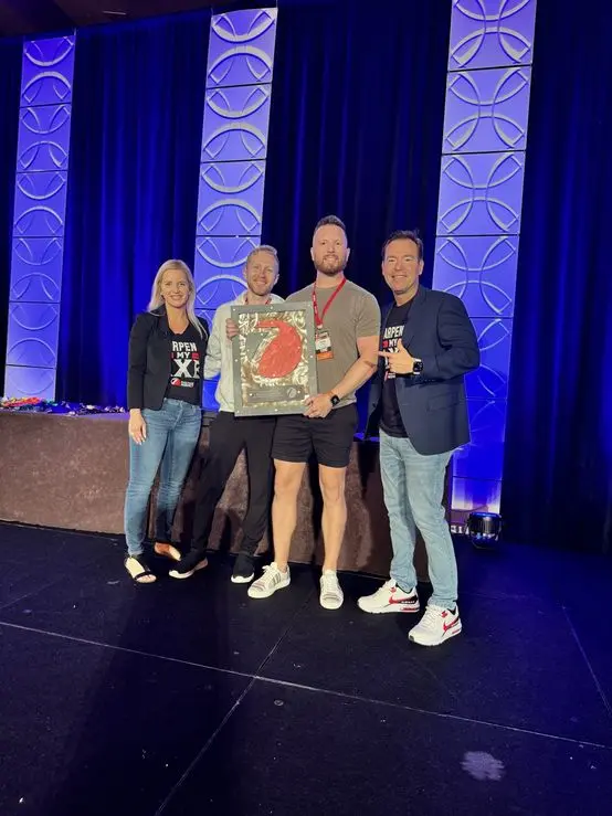 Austin and his Base Coat Marketing partner receiving their Seven Figure Agency plaque