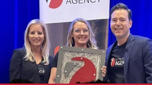 April Edwards receiving her Seven Figure Agency award with Josh and Yesenia Nelson