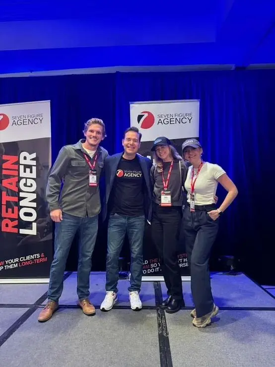 Luke with Josh Nelson and fellow members at a Seven Figure Agency event