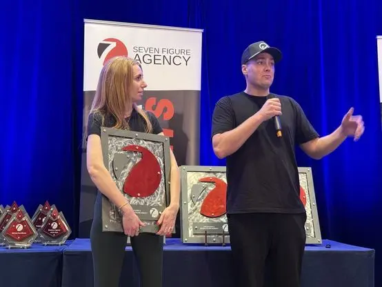 Tim on stage as the Seven Figure Agency awards are handed out