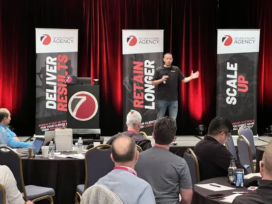 Presenting from the main stage at a Seven Figure Agency event