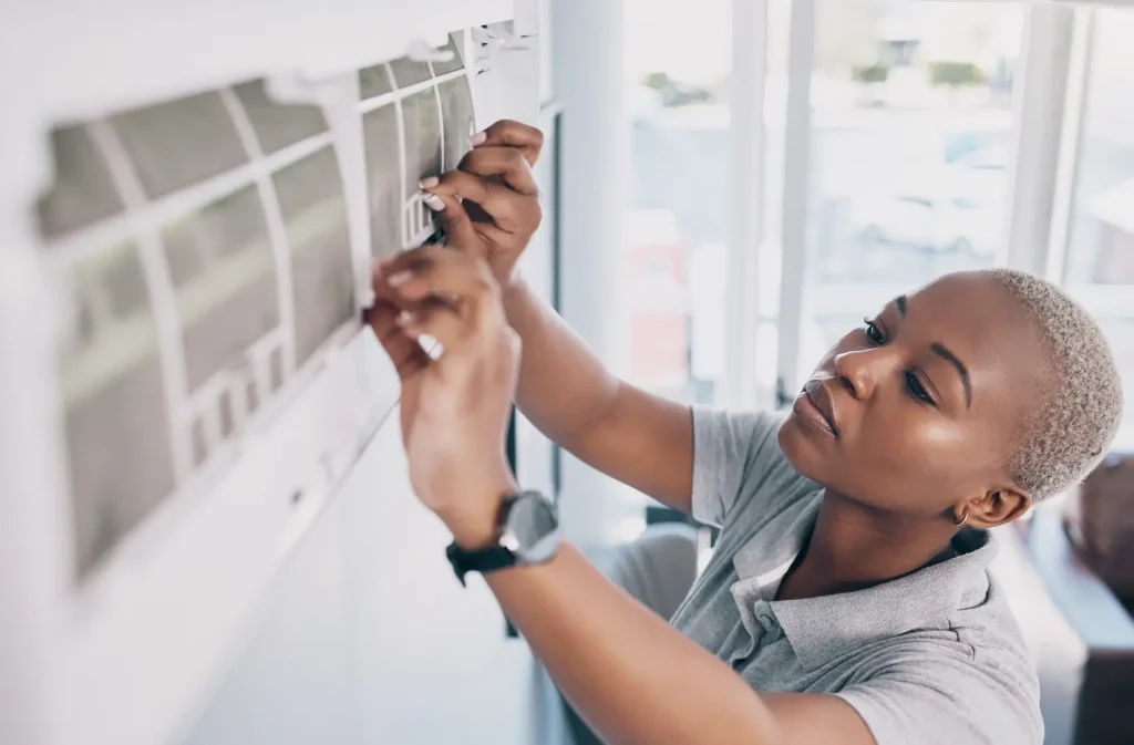 Woman inspecting AC unit