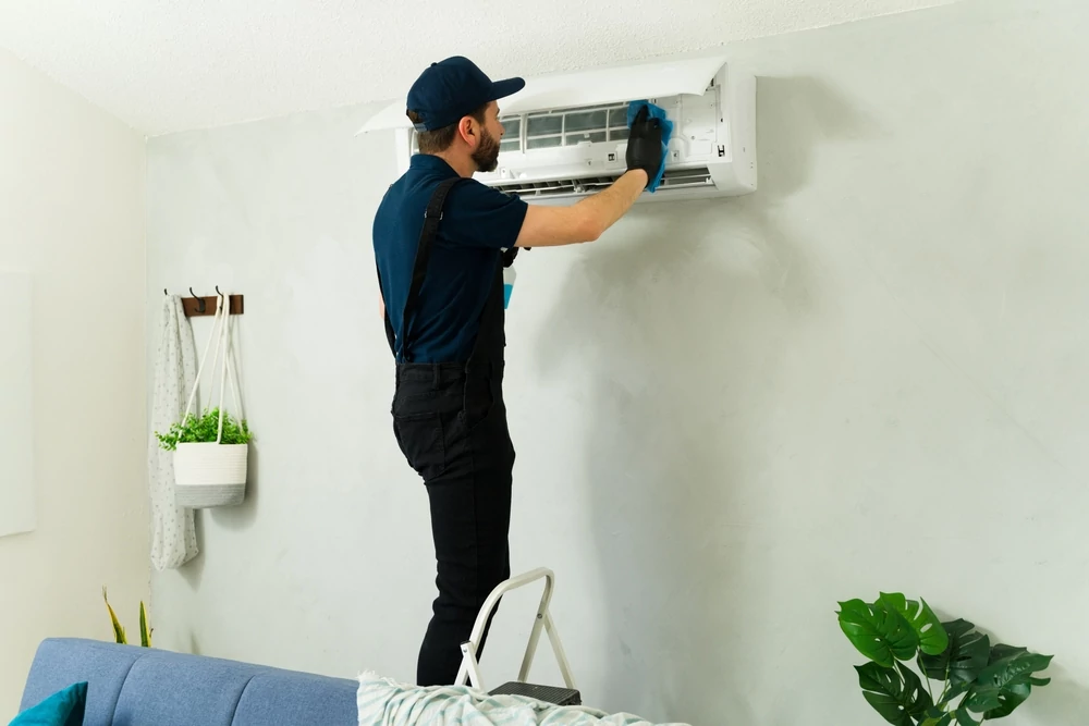 Technician working on mini split unit