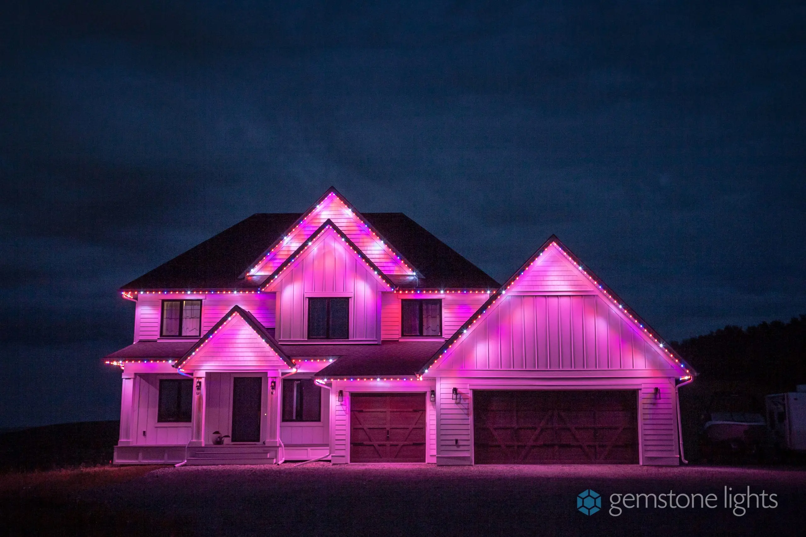 A home glowing pink from its color changing soffit lights