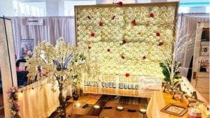white and red flower wall and white cherry blossom tree with lights for corporate events and weddings display