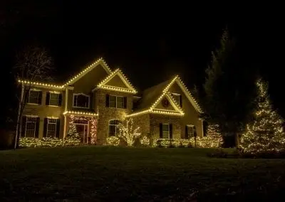 White lights on a home in Latham New York decorated for Christmas