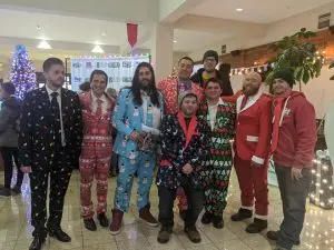 decorating elfperts in ugly Christmas suits