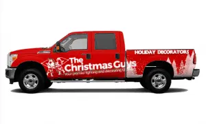 red truck wrapped with The Christmas Guys logo and words holiday decorators