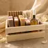 Wooden botanical gift crate with handmade soap bars, dropper bottle, small containers and textured bath pouch