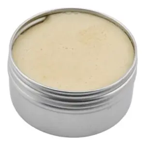 Open one ounce Thrive Botanical Balm tin showing the neutral balm texture