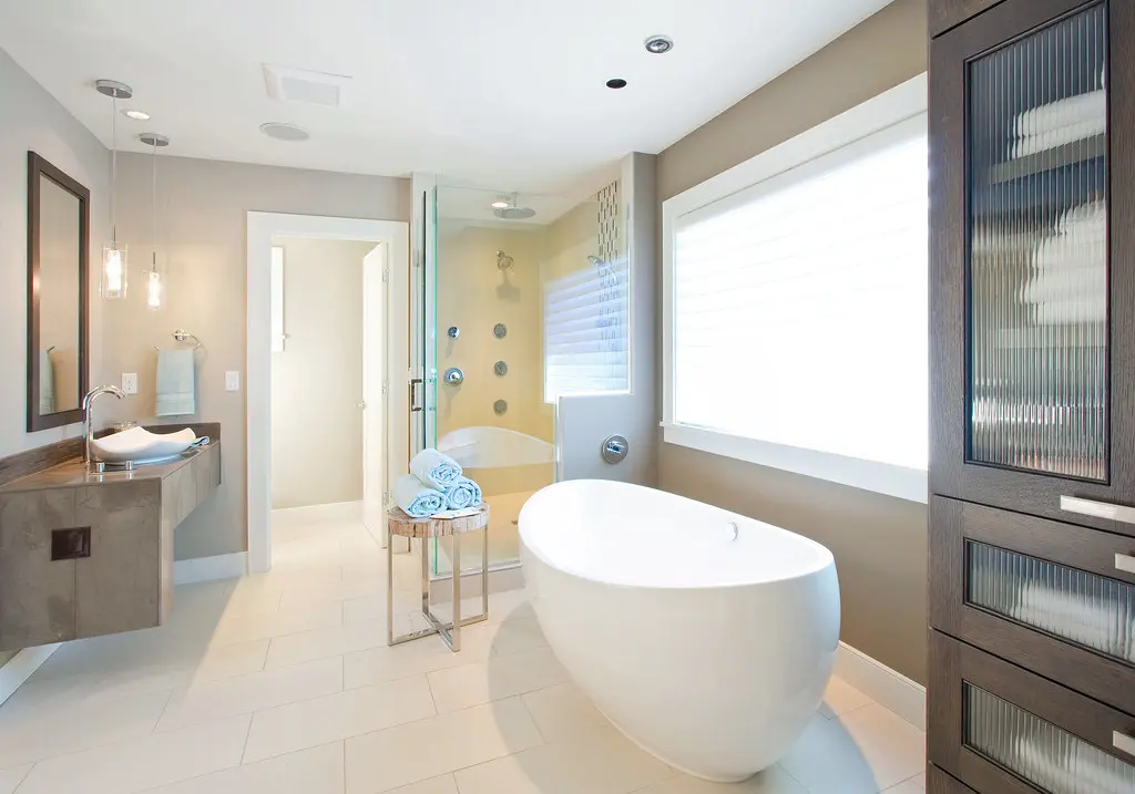 Bright guest bathroom with folded towels for a simple summer hosting routine