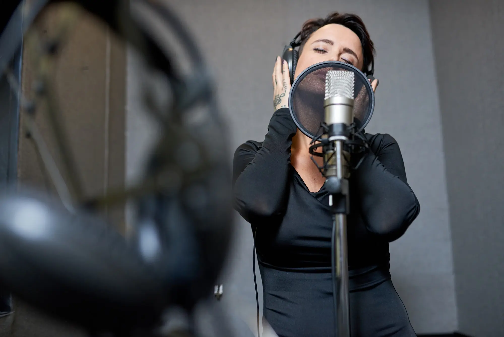 Beautiful woman singing in studio