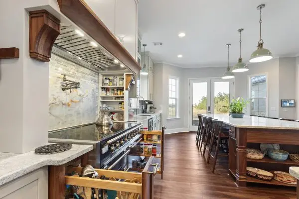Custom kitchen renovation with blue range, pot filler and pull out spice cabinets