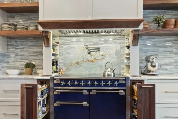 custom kitchen remodel with blue oven and range and custom spice rack pull outs