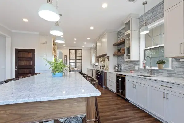 Custom kitchen renovation with white cabinets and two islands