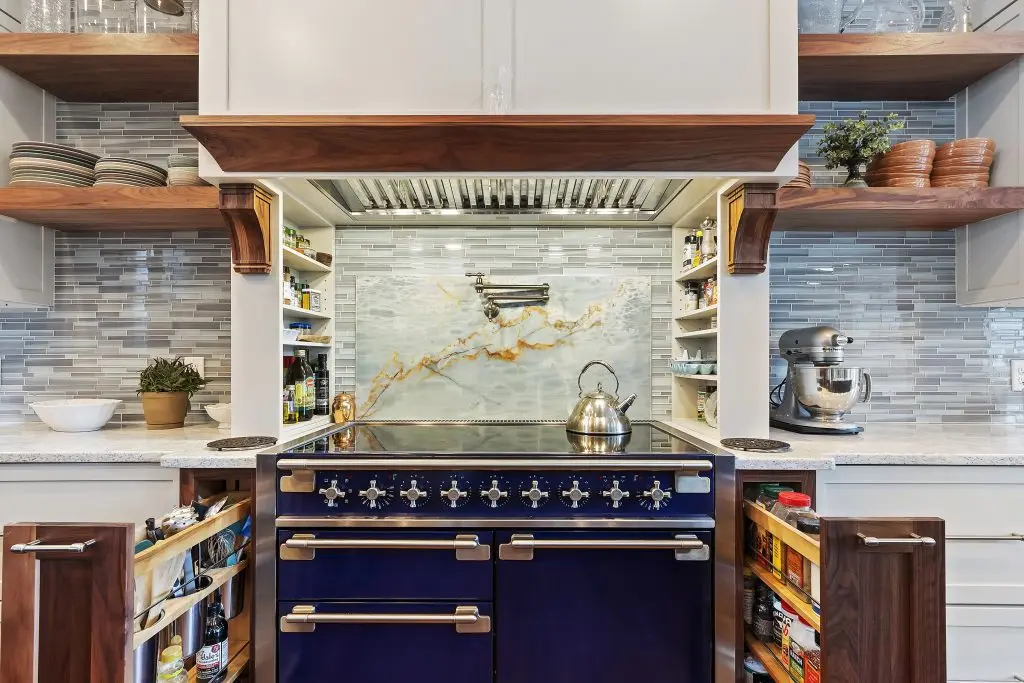 Range Detail Custom kitchen renovation with blue range, pot filler and pull out spice cabinets