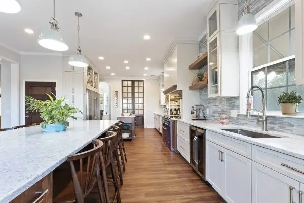 Custom kitchen renovation with white cabinets and two islands