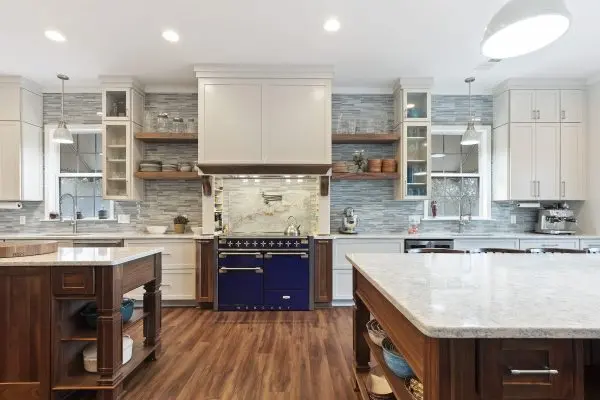custom kitchen renovation with two islands and blue range