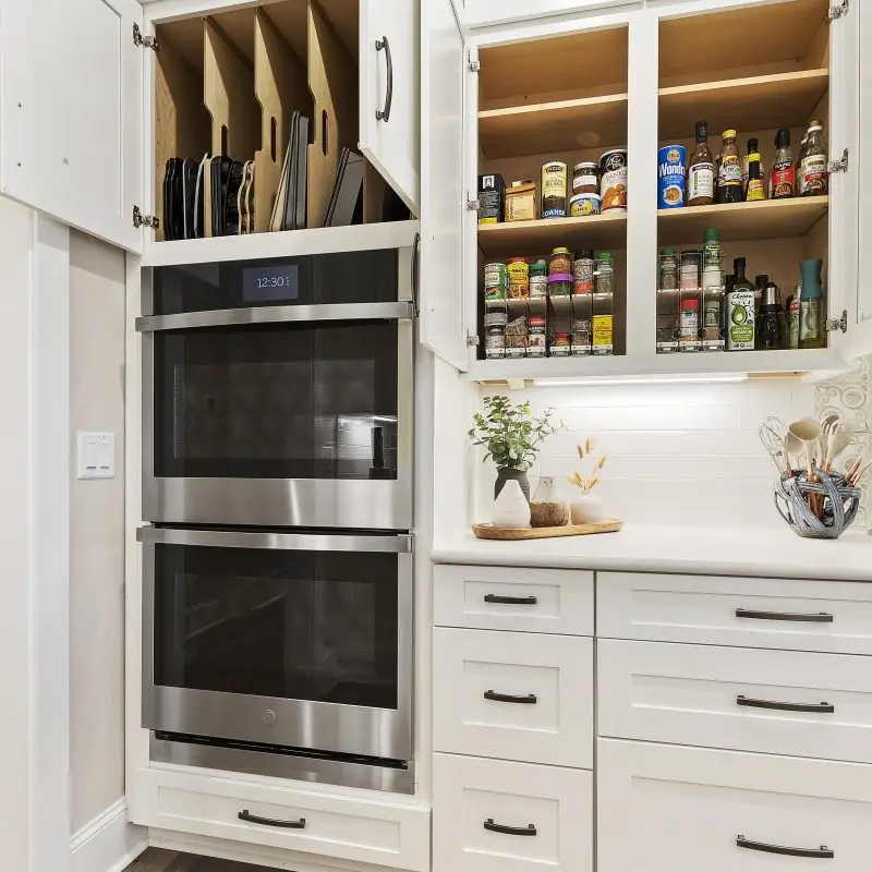 white kitchen with custom cabinets and vertical pan storage Margaritaville, SC new construction