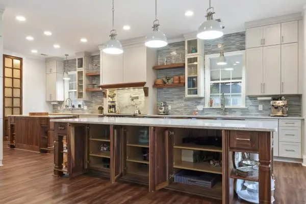 white kitchen remodel with large center island and custom storage cabinets