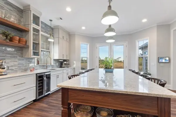 white custom kitchen remodel with large walnut island