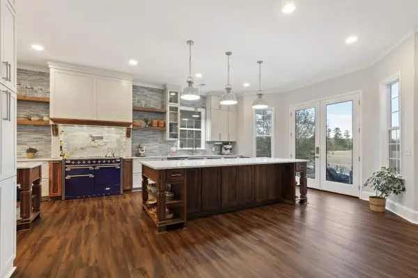 Custom kitchen renovation with large island and blue range